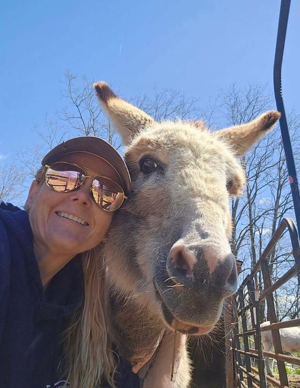 Woman sitting peacefully with a large horse